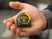 Hand holding a Stanley FatMax tape measure